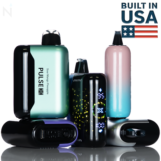 Multiple multicolored disposable vapes on a white background reflected on a mirrored surface with the center vape's screen illuminated with lights. 